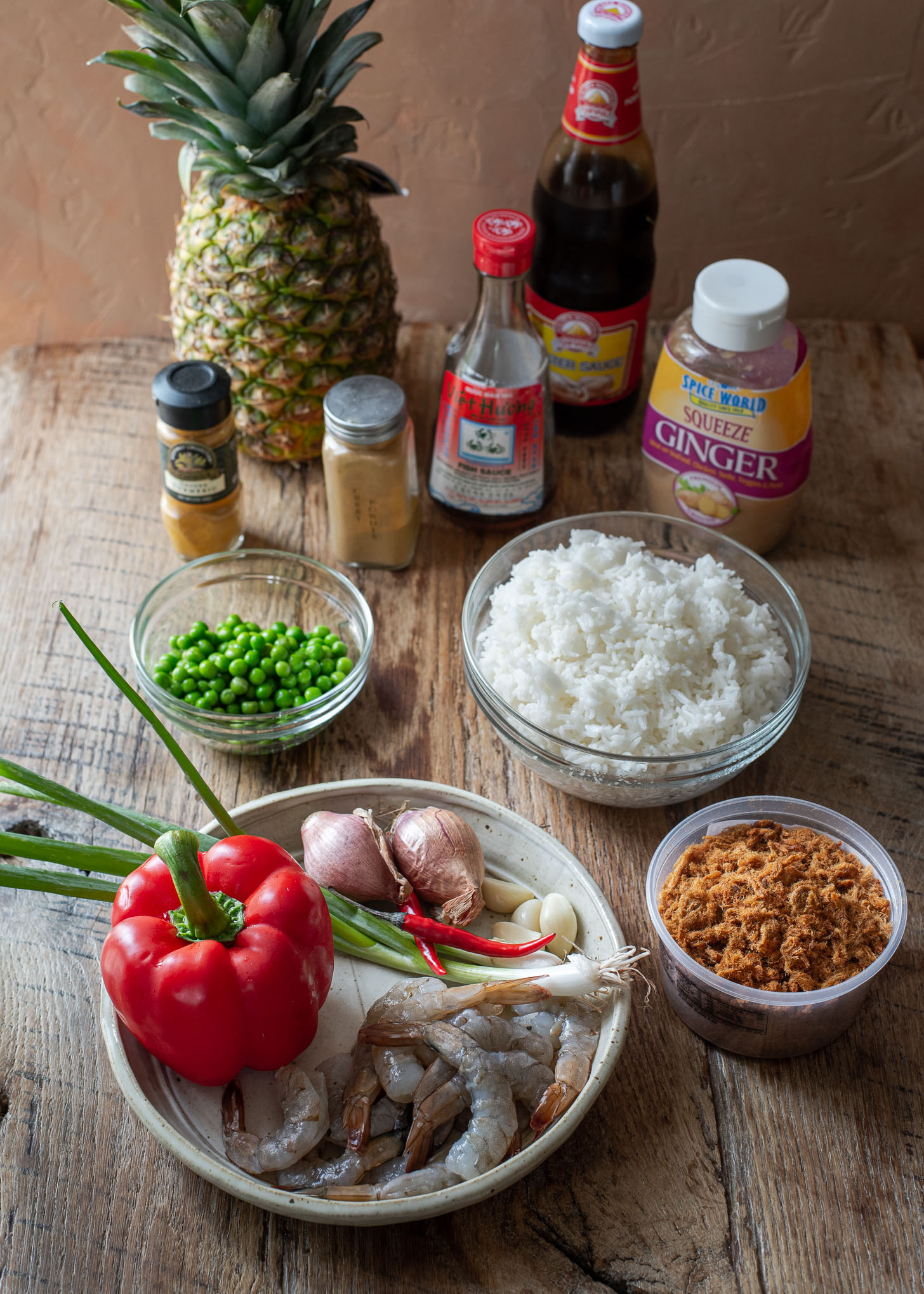 Ingredients for making Thai pineapple fried rice are presented.