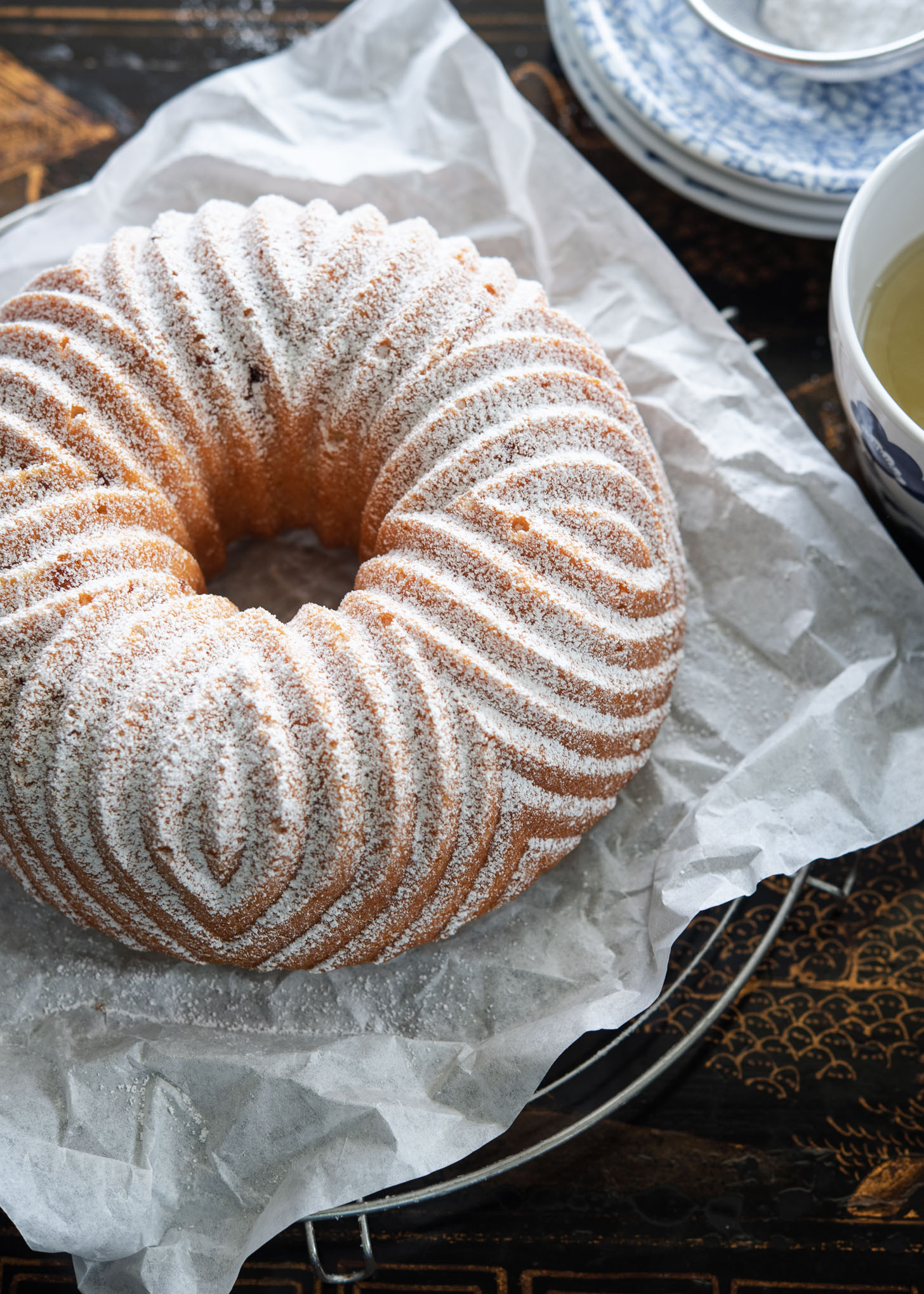 Peach pound cake is baked in a barbarian bundt pan and dusted with powdered sugar.