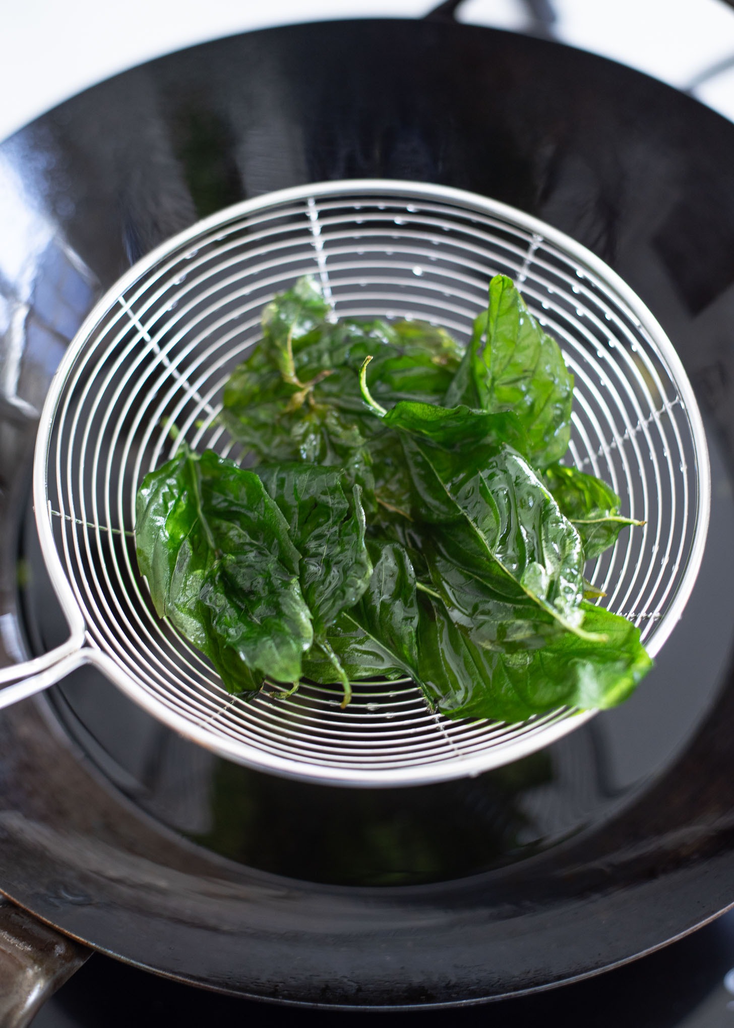 Deep fried Thai basil is showing the vibrant green color.