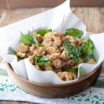 Taiwanese popcorn chicken is served in a container with toothpicks.