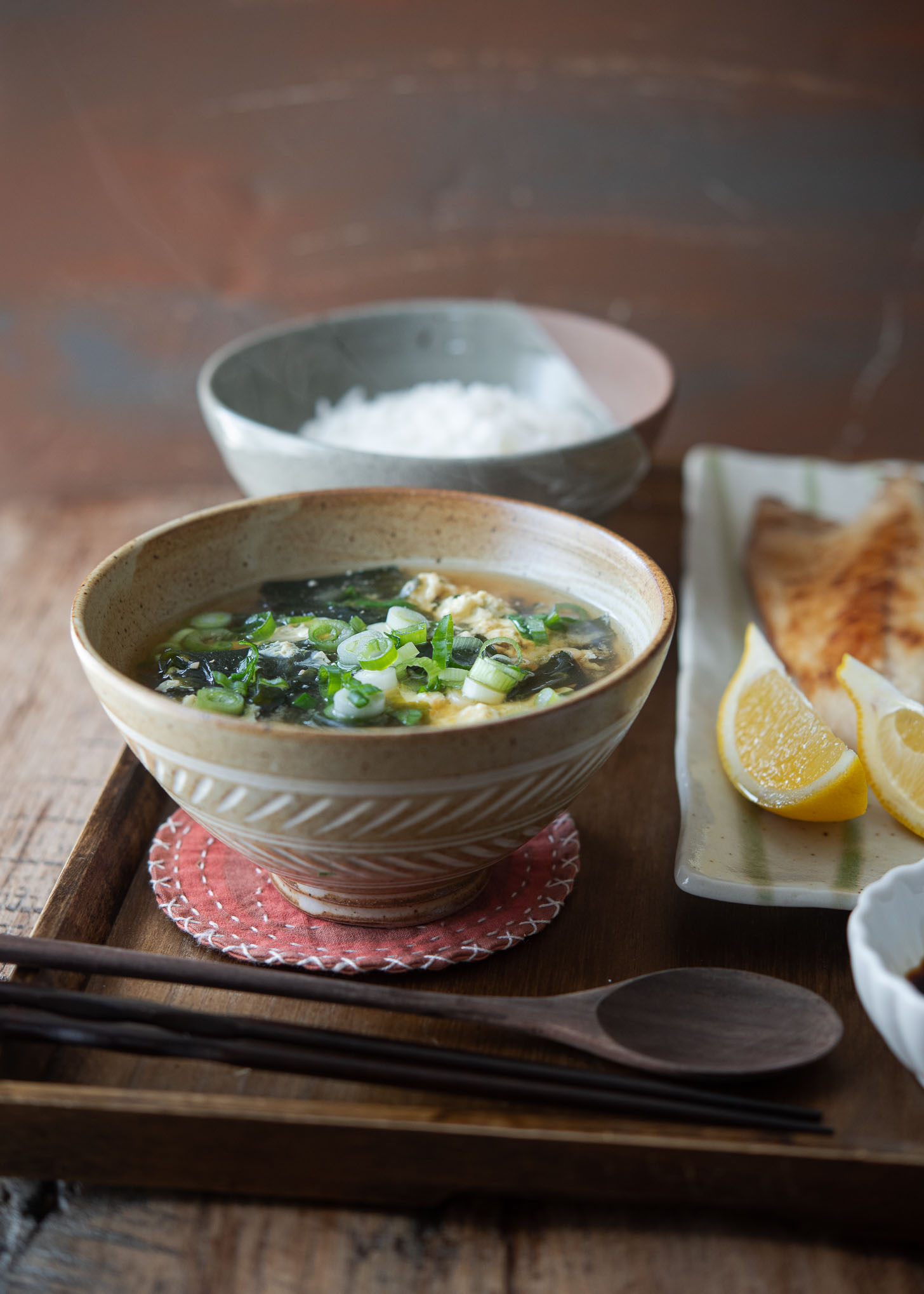 Seaweed egg drop soup is garnished with green onion and served as a breakfast.