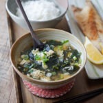 Seaweed egg drop soup is served with rice and fish.