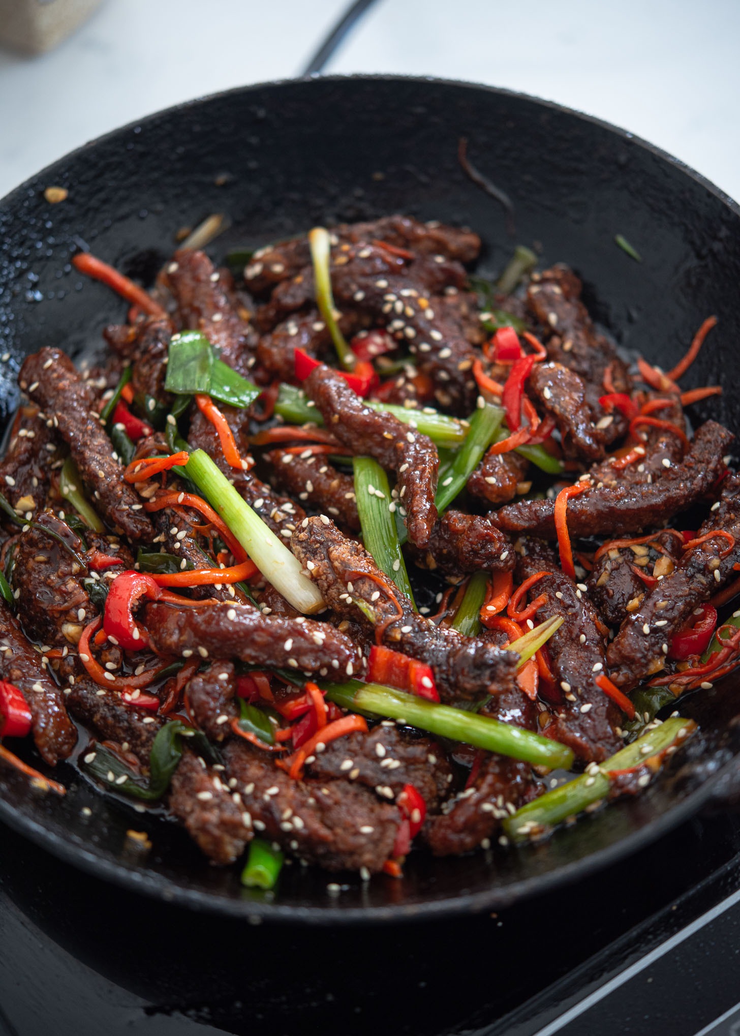 Garnish crispy beef with sesame seeds to finish off.