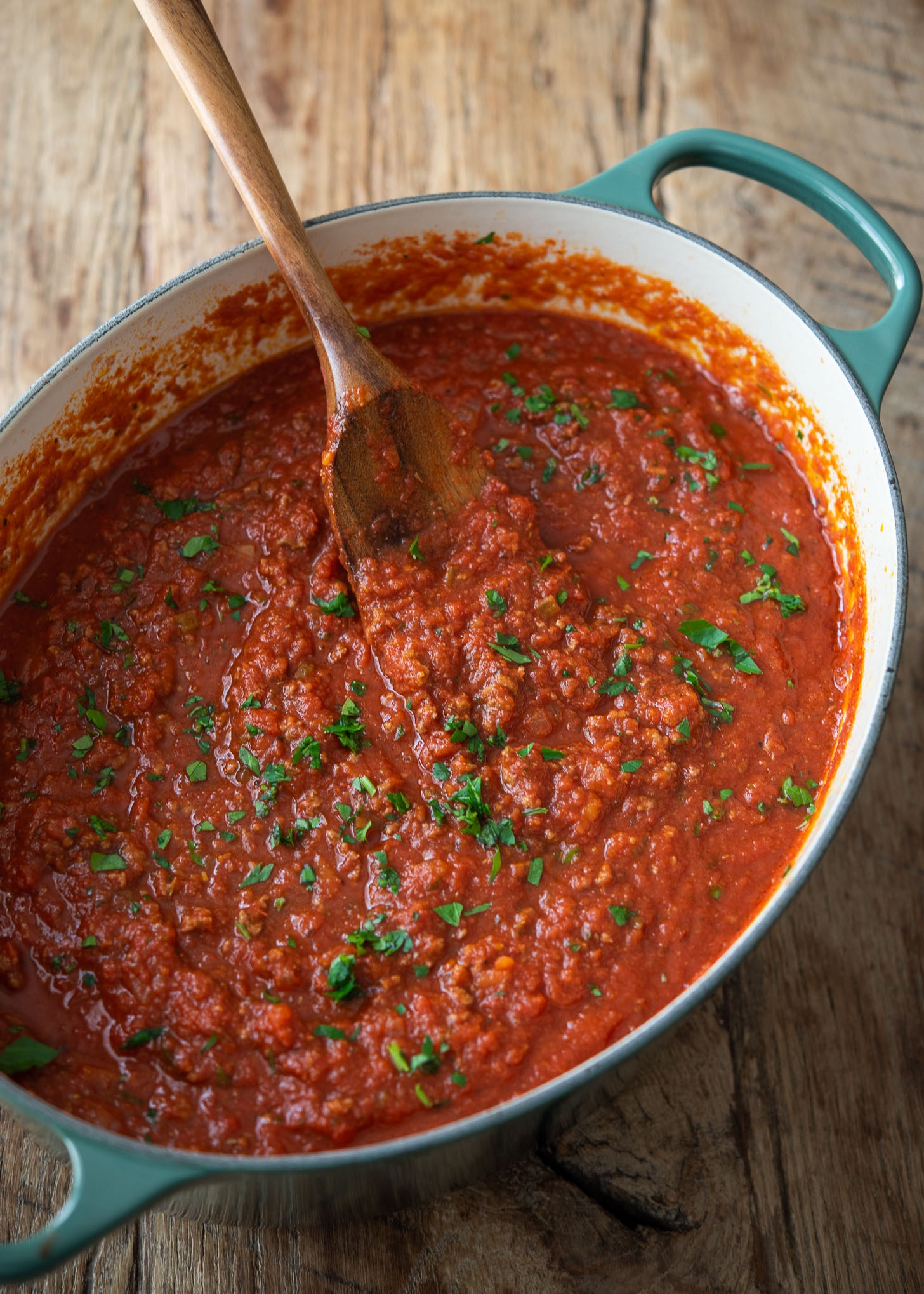 A big batch of thick homemade spaghetti sauce simmered in a large pot.