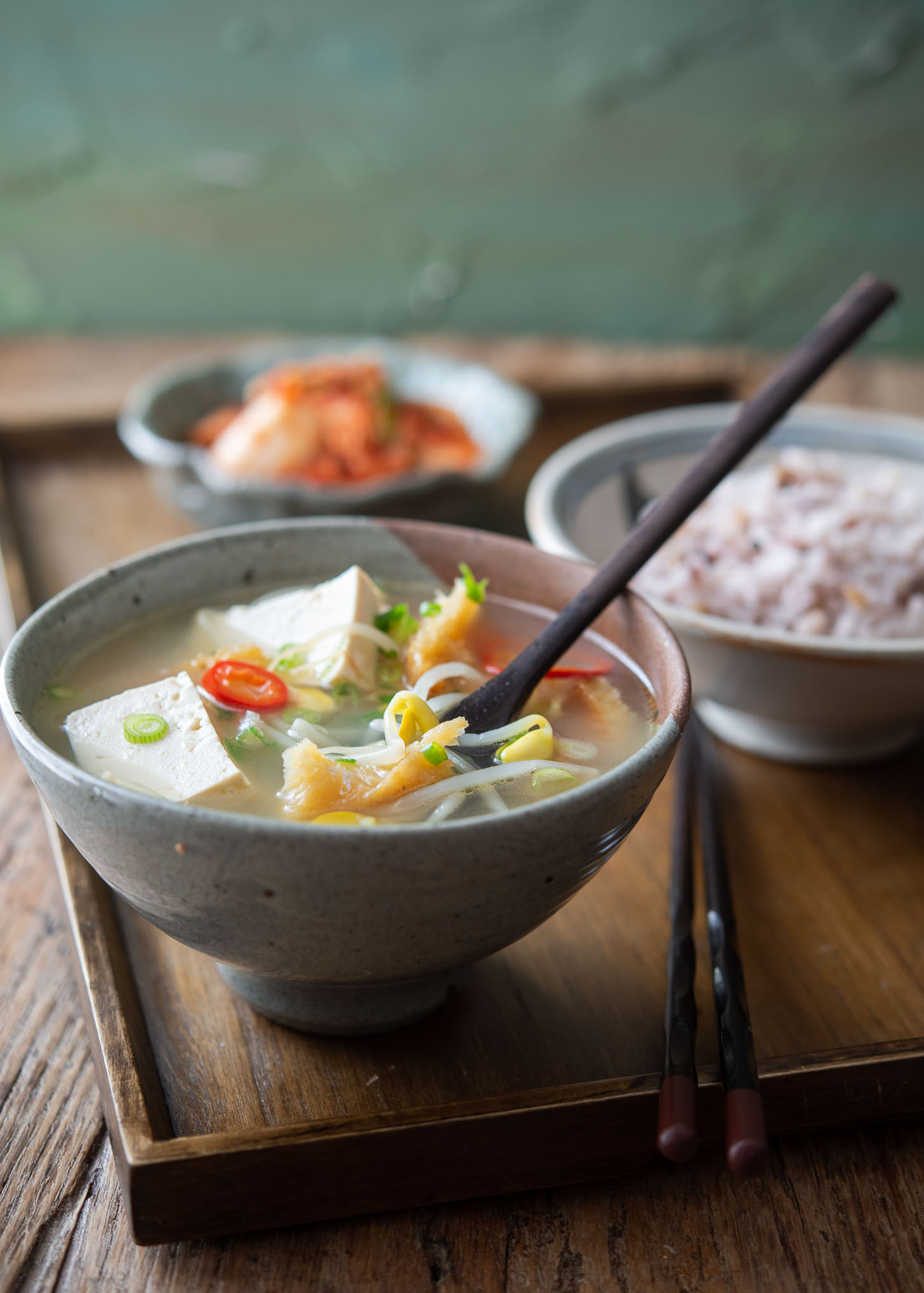 Korean pollock soup is served with rice and kimchi.