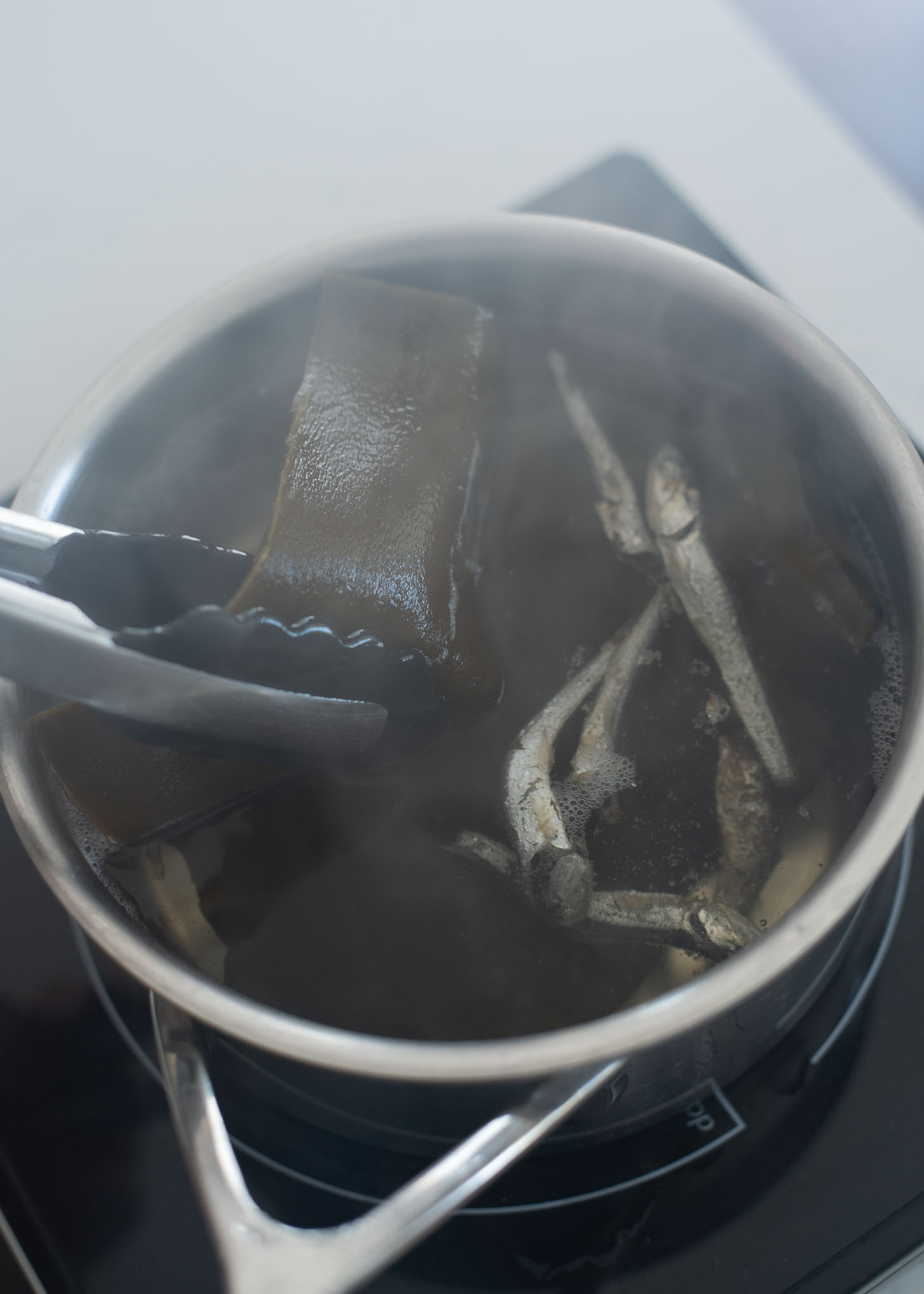 Anchovy sea kelp stock is simmered in a pot