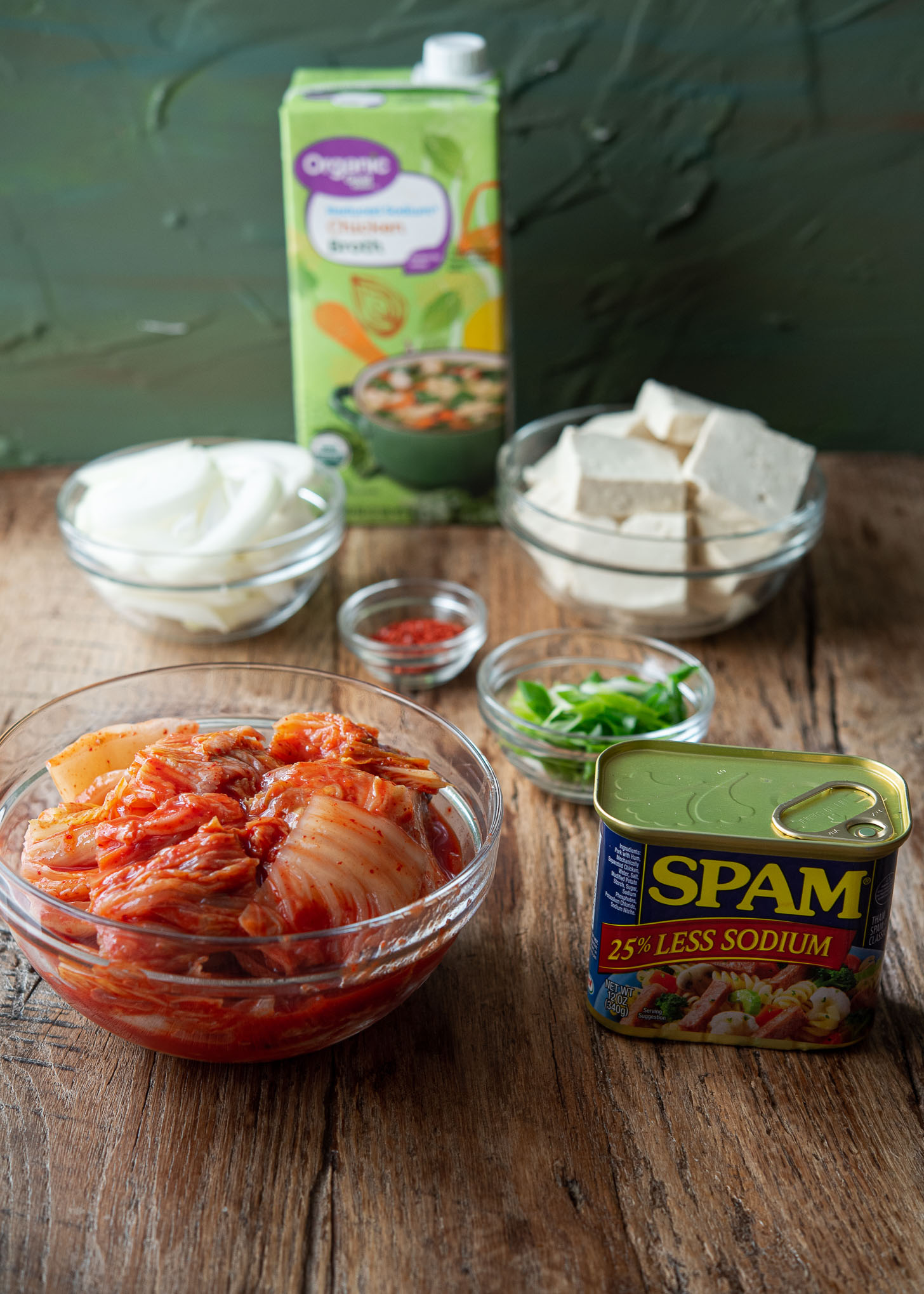 Ingredients to make Spam kimchi jjigae are presented.
