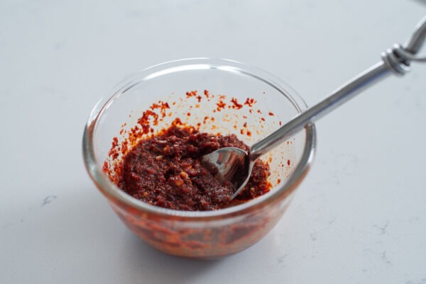 Seasoning for making Korena army stew is combined in a bowl.