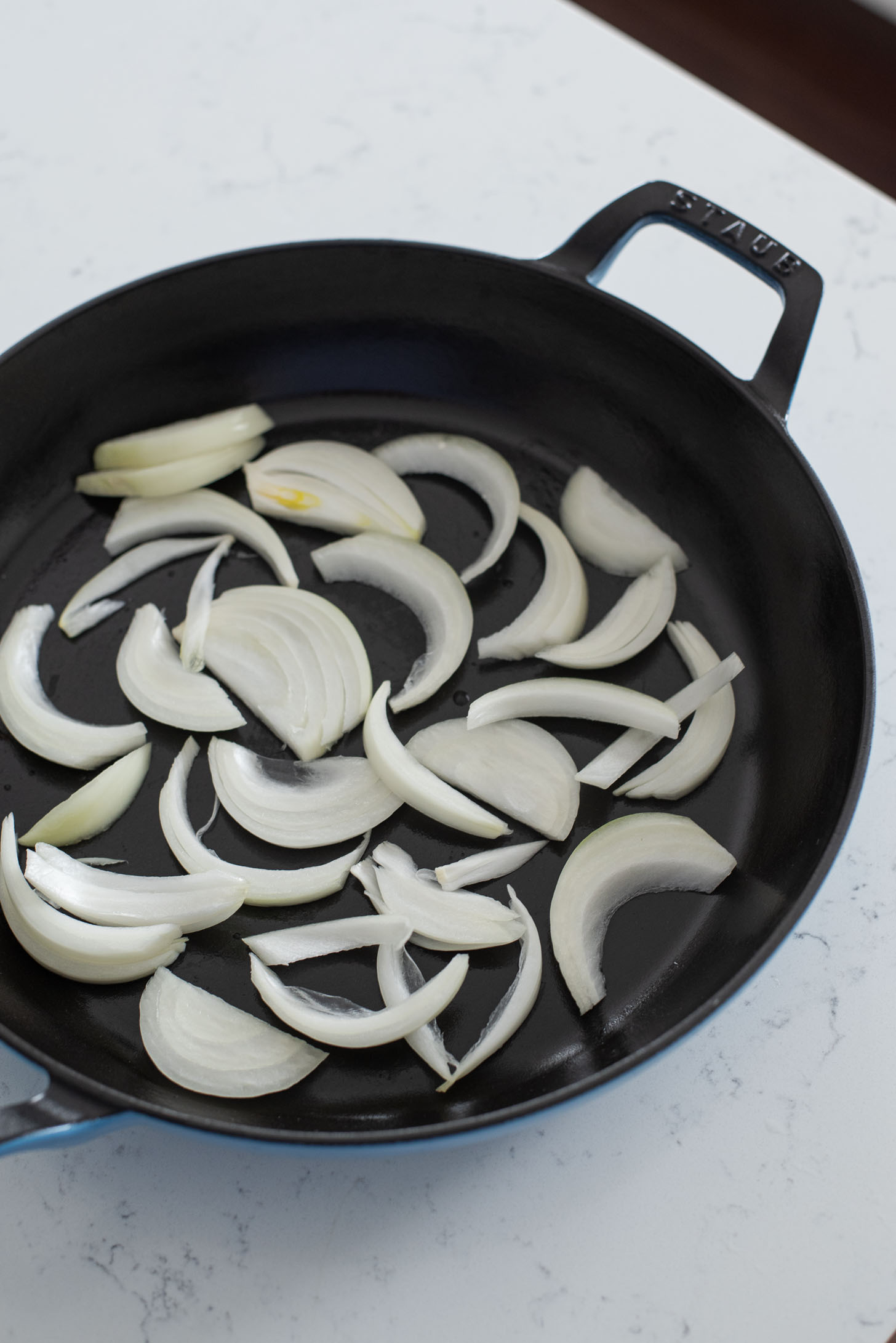 Onion slices on the bottom of budae jjigae pan.