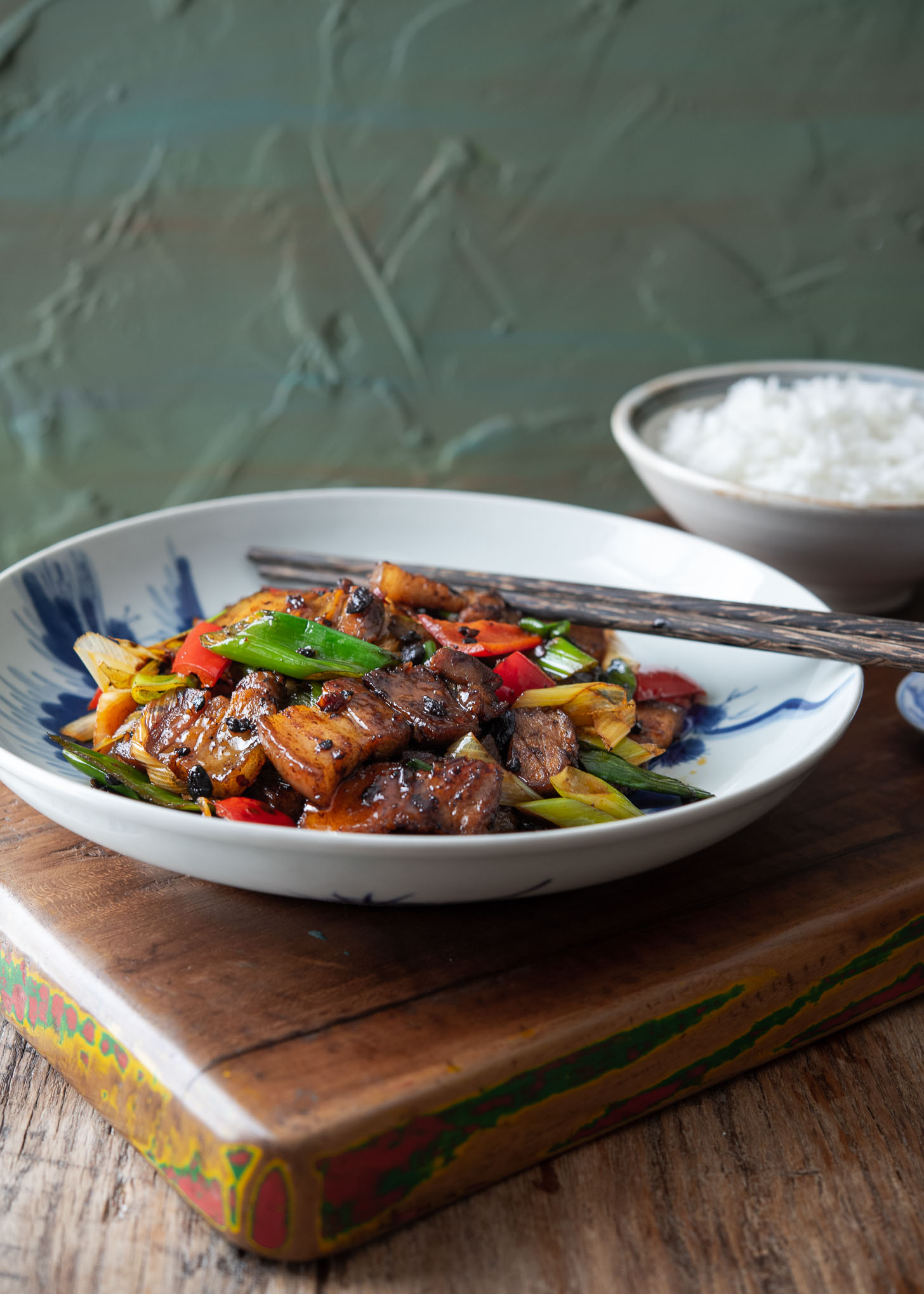 Chinese twice cooked pork, Sichuan pork stir-fry) presented with a bowl of rice.