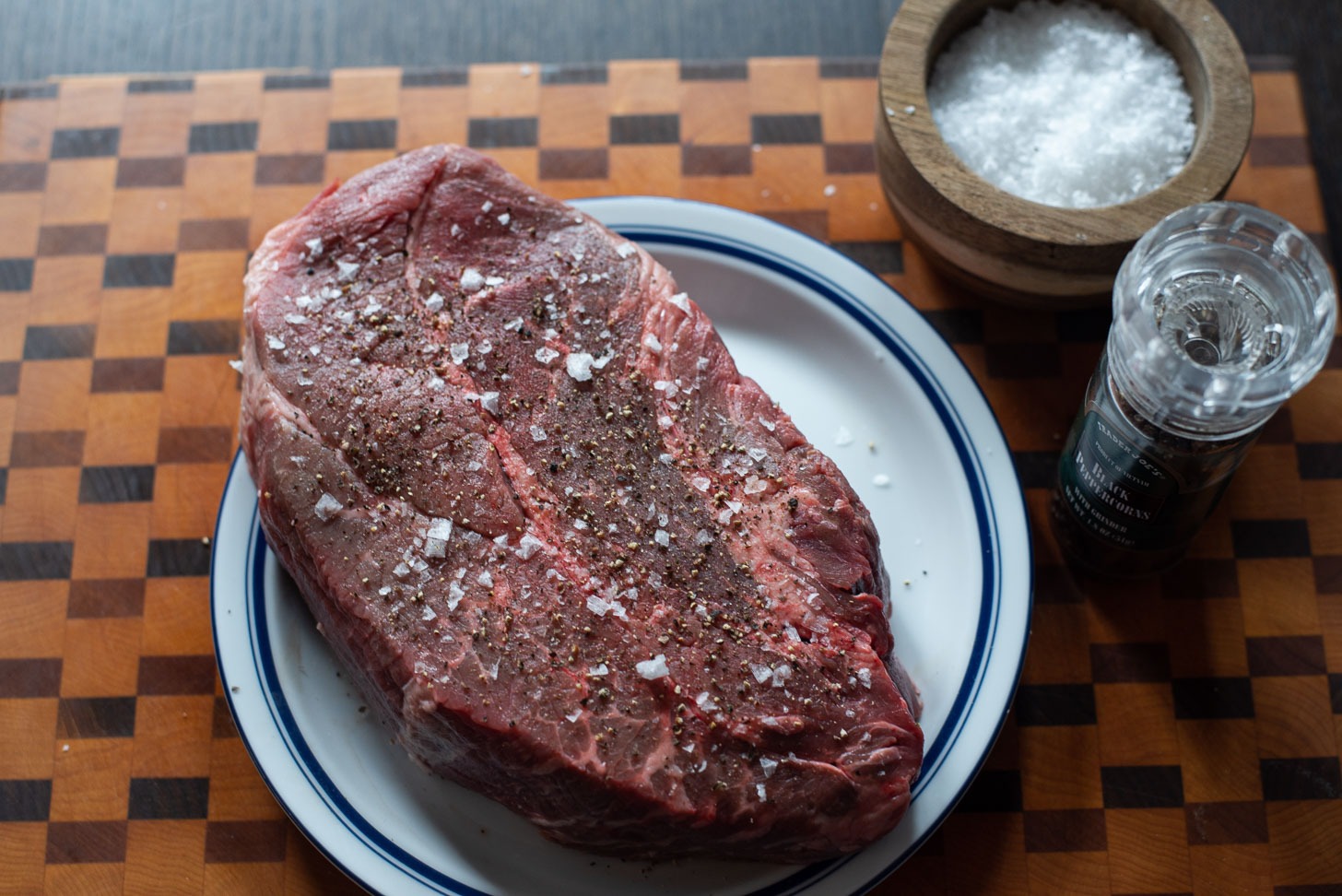 Beef chuck is seasoned with salt and pepper before searing.