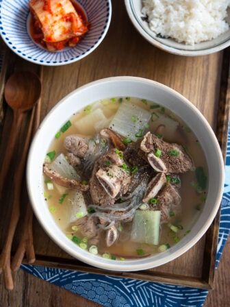 Galbitang soup made with beef short ribs are served with rice and kimchi.