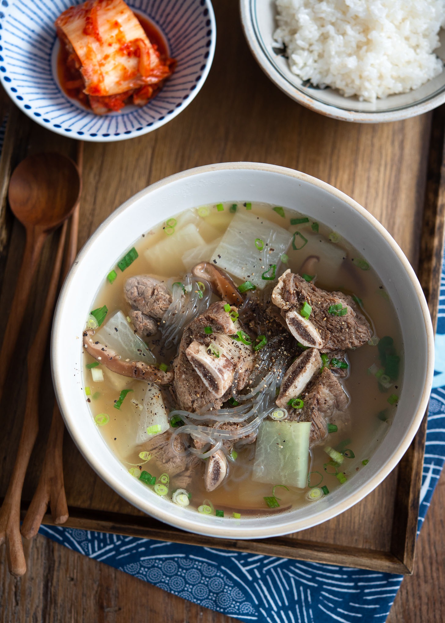 Galbitang soup made with beef short ribs are served with rice and kimchi.