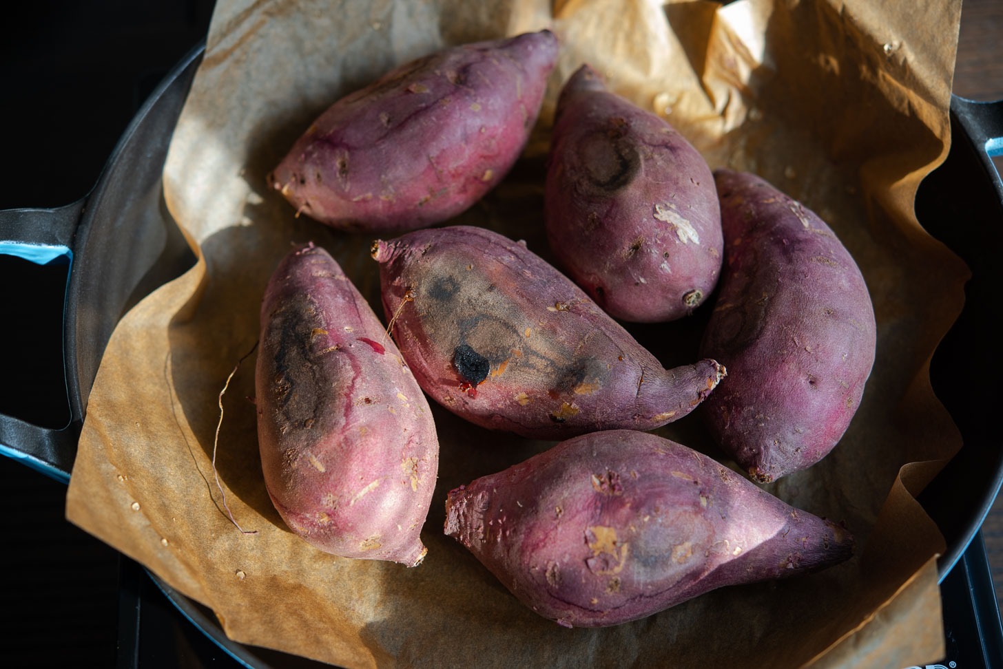 Pan roasted Korean sweet potatoes are charred on the outside.