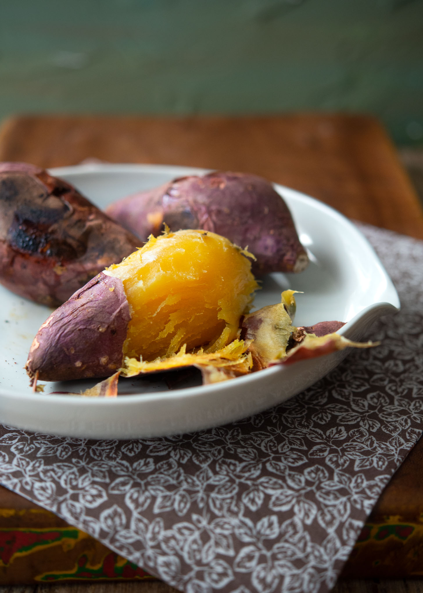 Peeled roasted Korean sweet potato is served on a white dish.