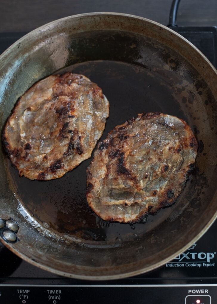 Dried filefish is roasted in butter and showing some brown spots on the surface.