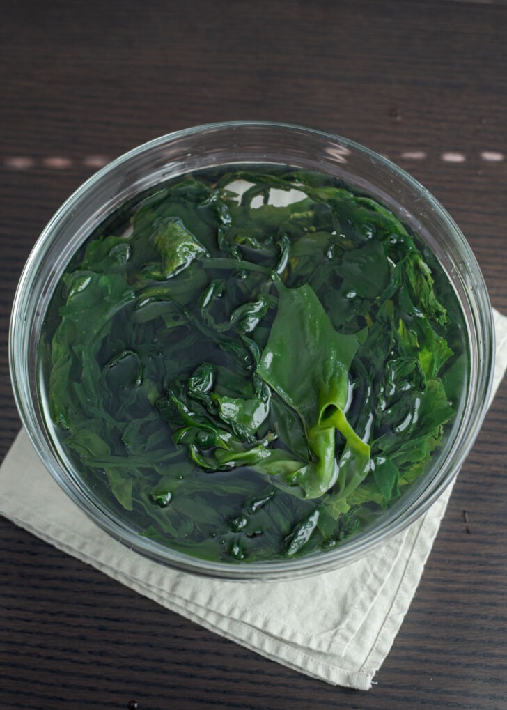 Dried seaweed is rehydrated in a bowl of water.