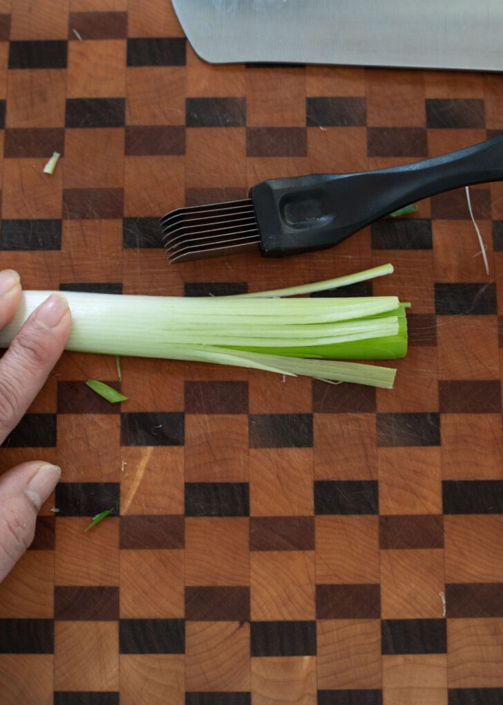 A green onion shredder is used to shred the green onion.