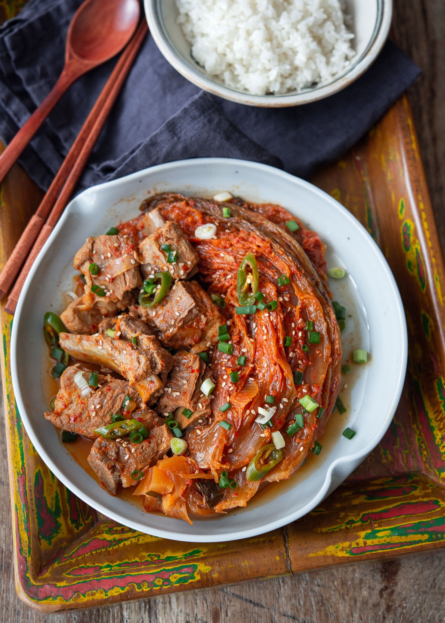 A plate of kimchi jjim with pork ribs served with rice.