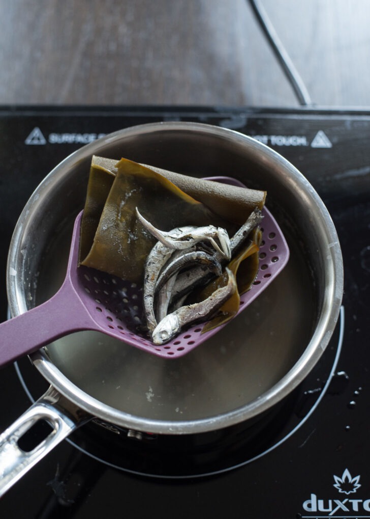 Anchovies and sea kelp are strained from the stock.