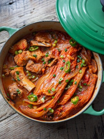 A pot of kimchi jjim is showing braised kimchi and pork ribs inside.