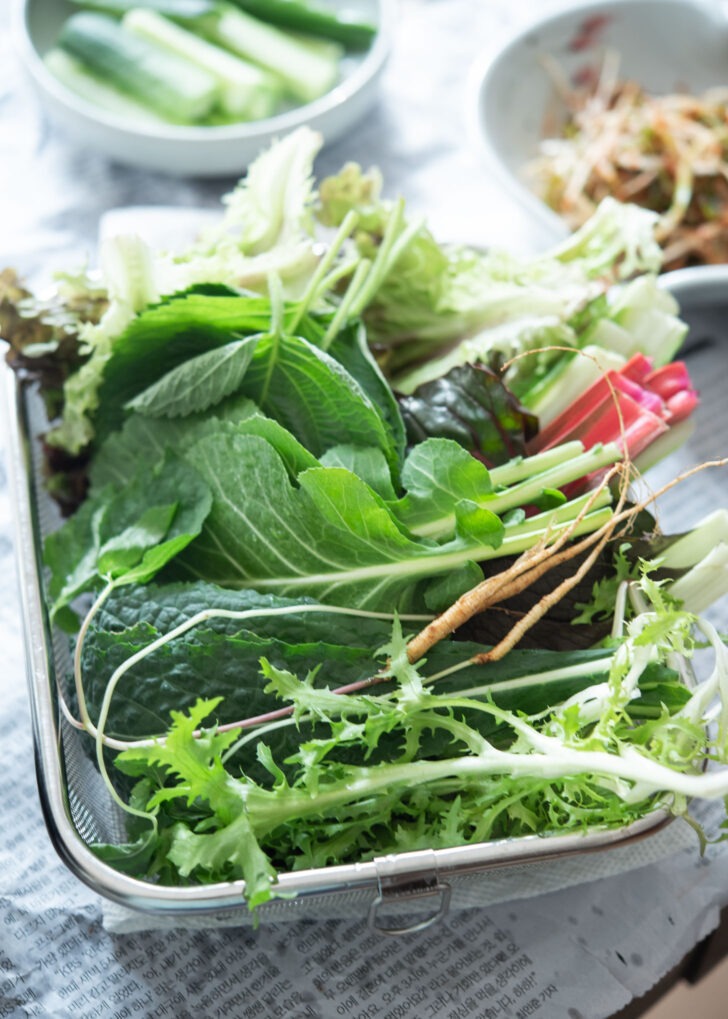 A variety of lettuce is collected in a basket for making samgyupsal-gui.