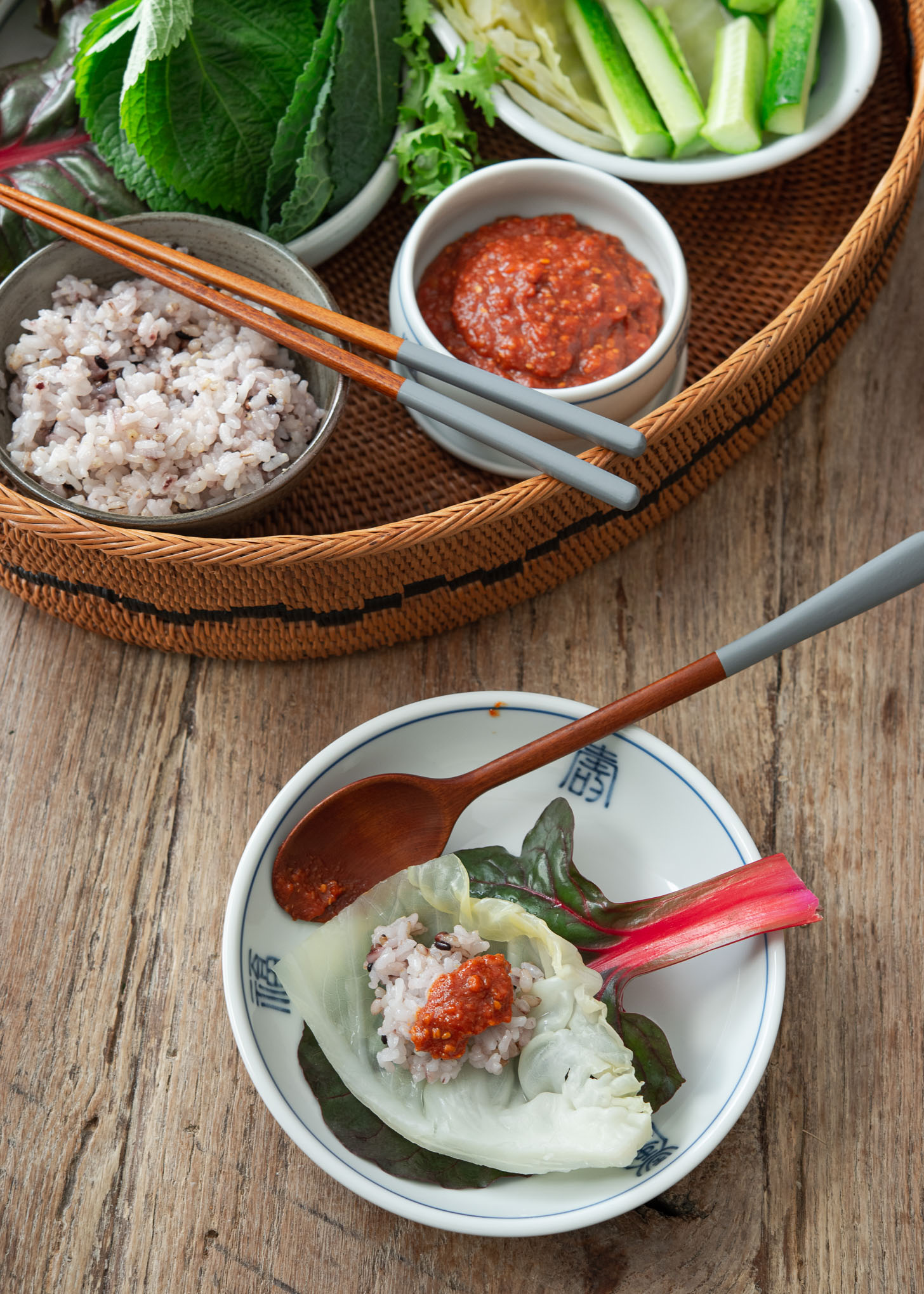 A dollop of ssamjang is placed on top of rice and vegetables.