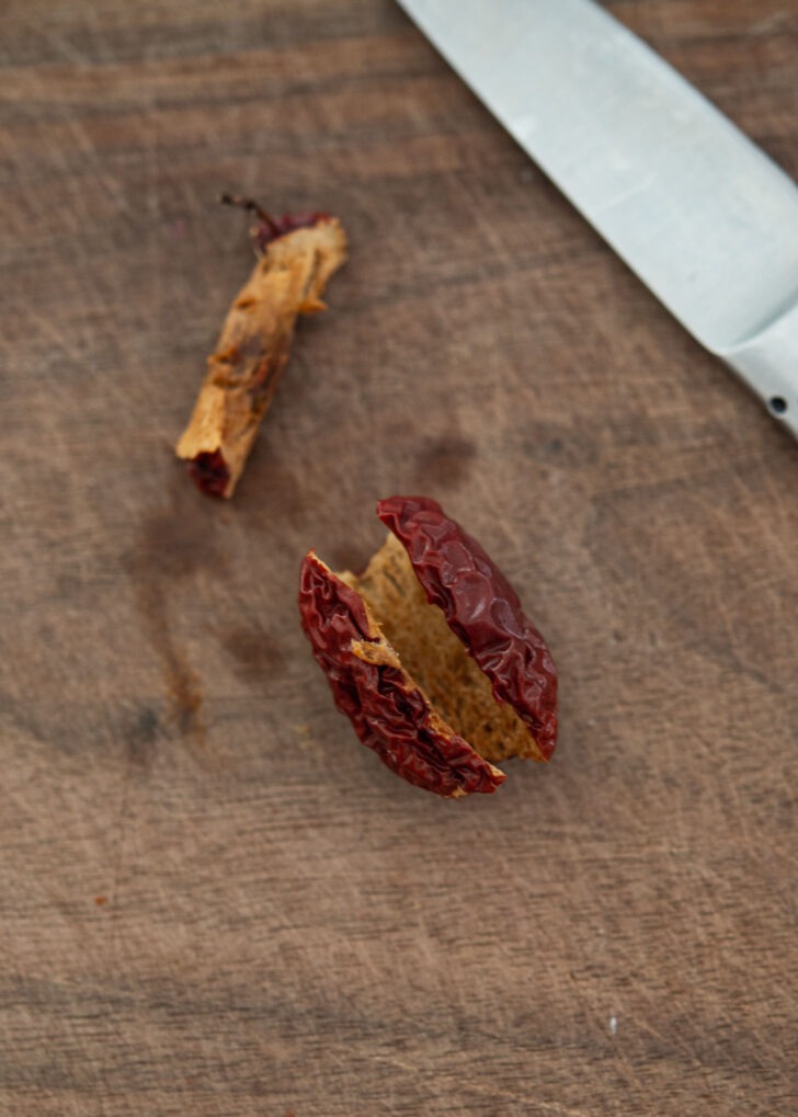 A seed is removed from dried jujube.