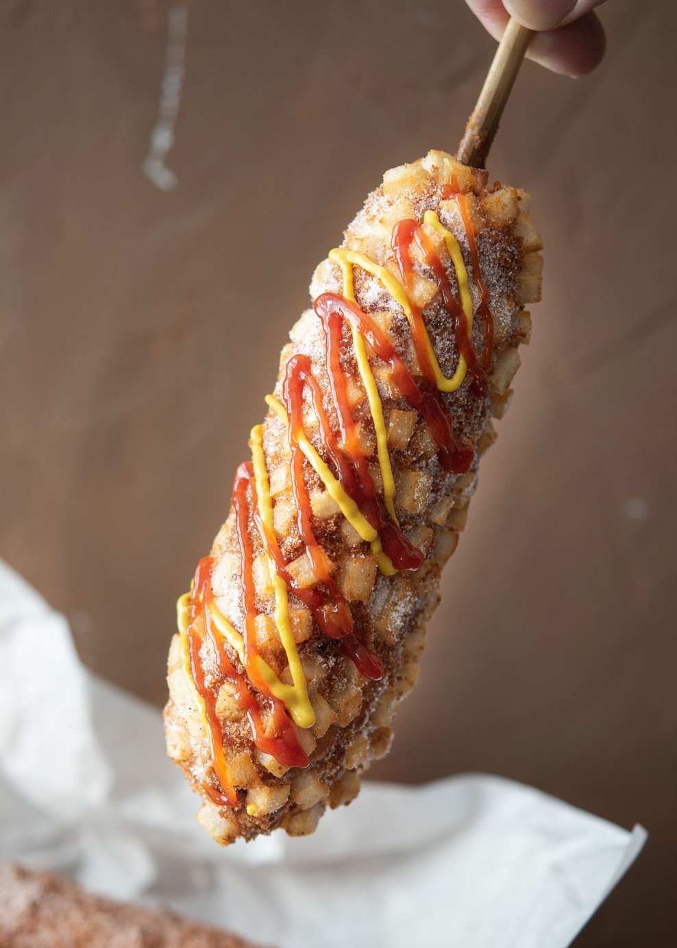 Crispy potato Korean corn dog with sweet and savory condiments