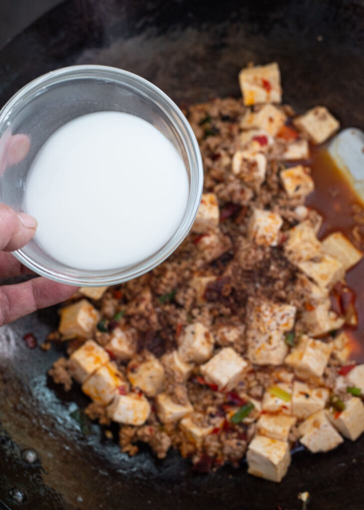 Starch slurry is added to thicken the  mapo tofu sauce.