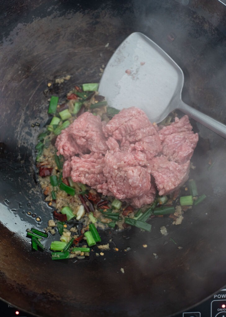 Ground pork added to the aromatics for cooking mapo tofu.