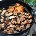 Korean samgyupsal with grilled pork belly and kimchi in a pan