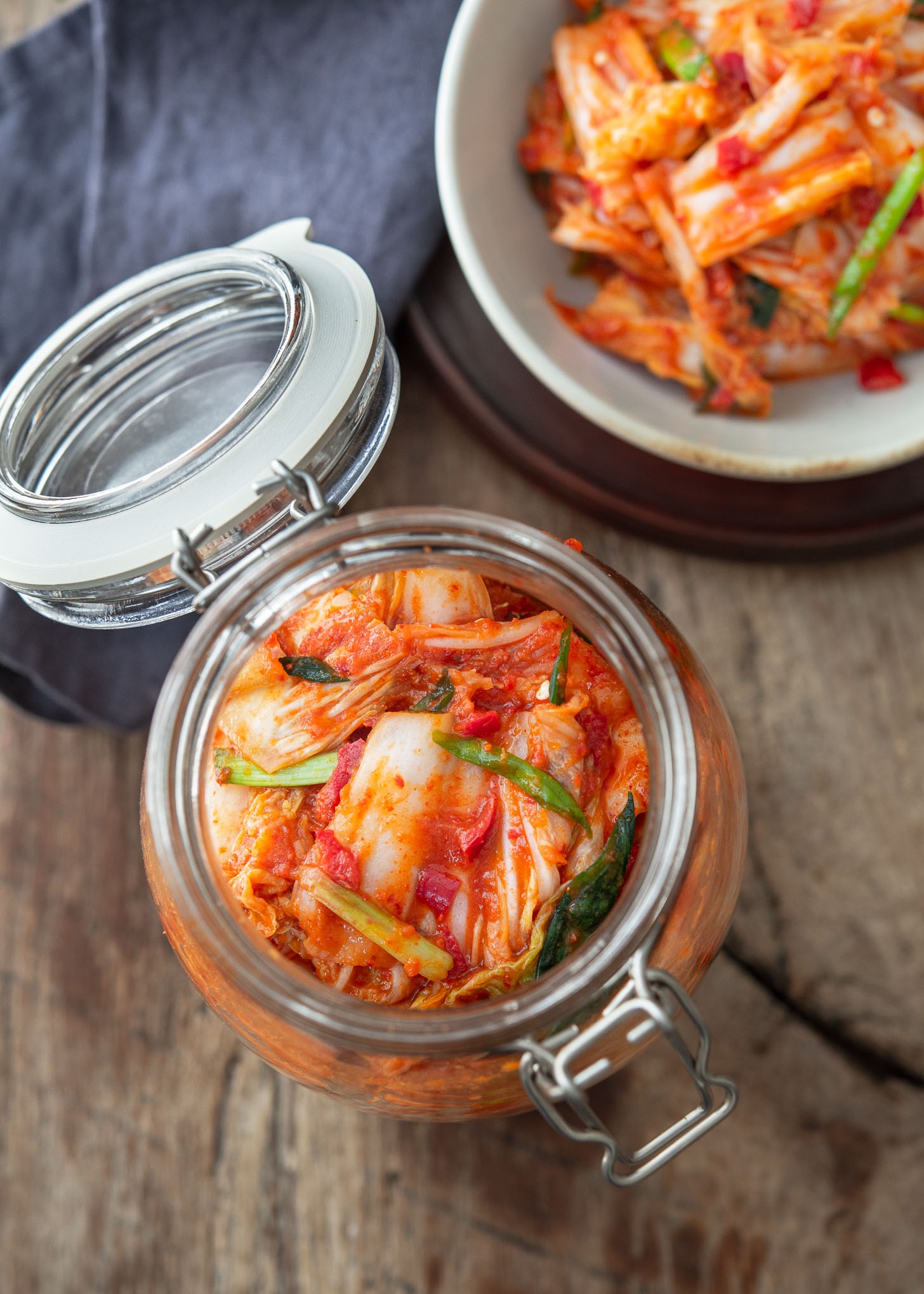 A jar of vegan kimchi is opened and showing the kimchi inside.