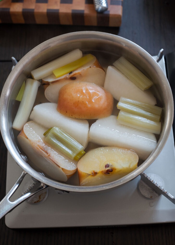 Vegetable-fruit stock being simmered in a pot.