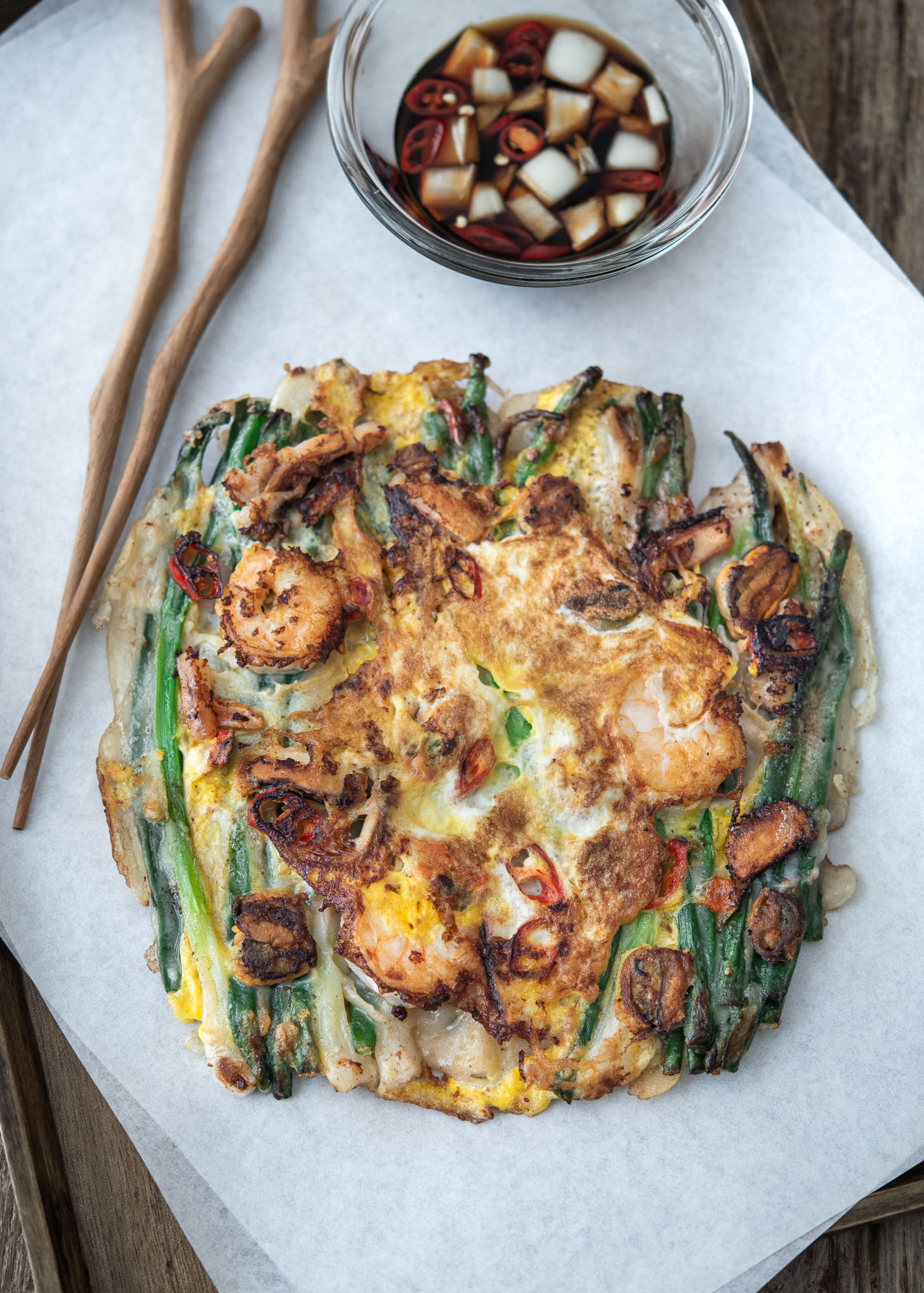 Korean scallion pancake, pajeon, made with seafood served with dipping sauce