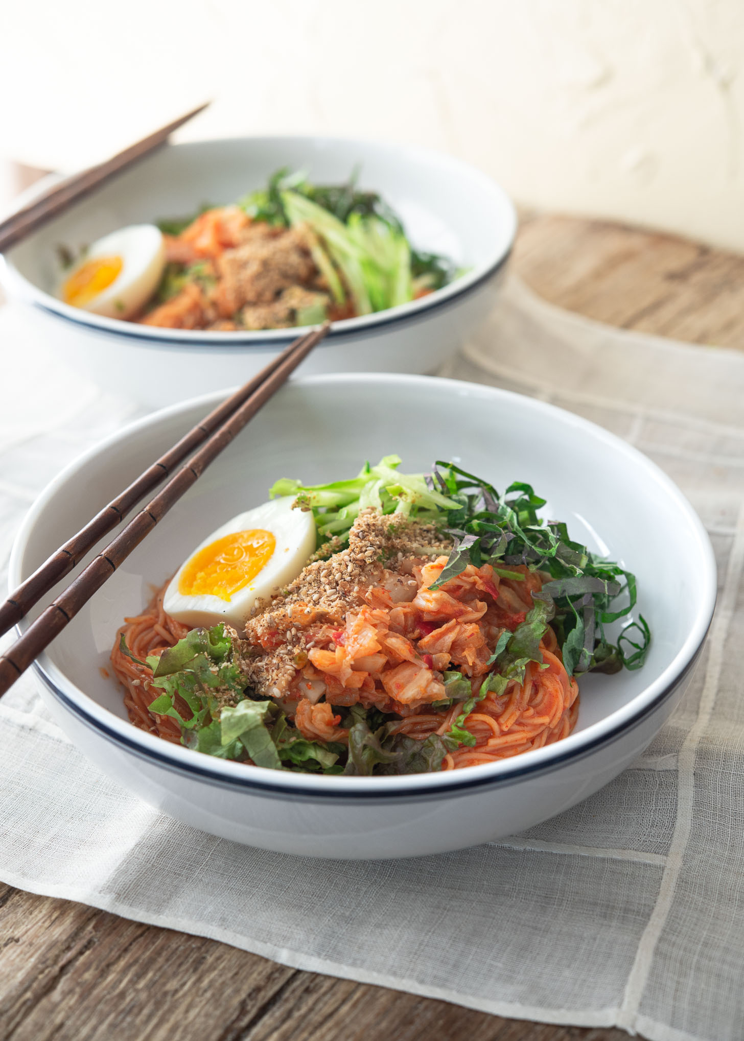 Korean cold noodles (Bibim guksu) garnished with vegetables and egg.