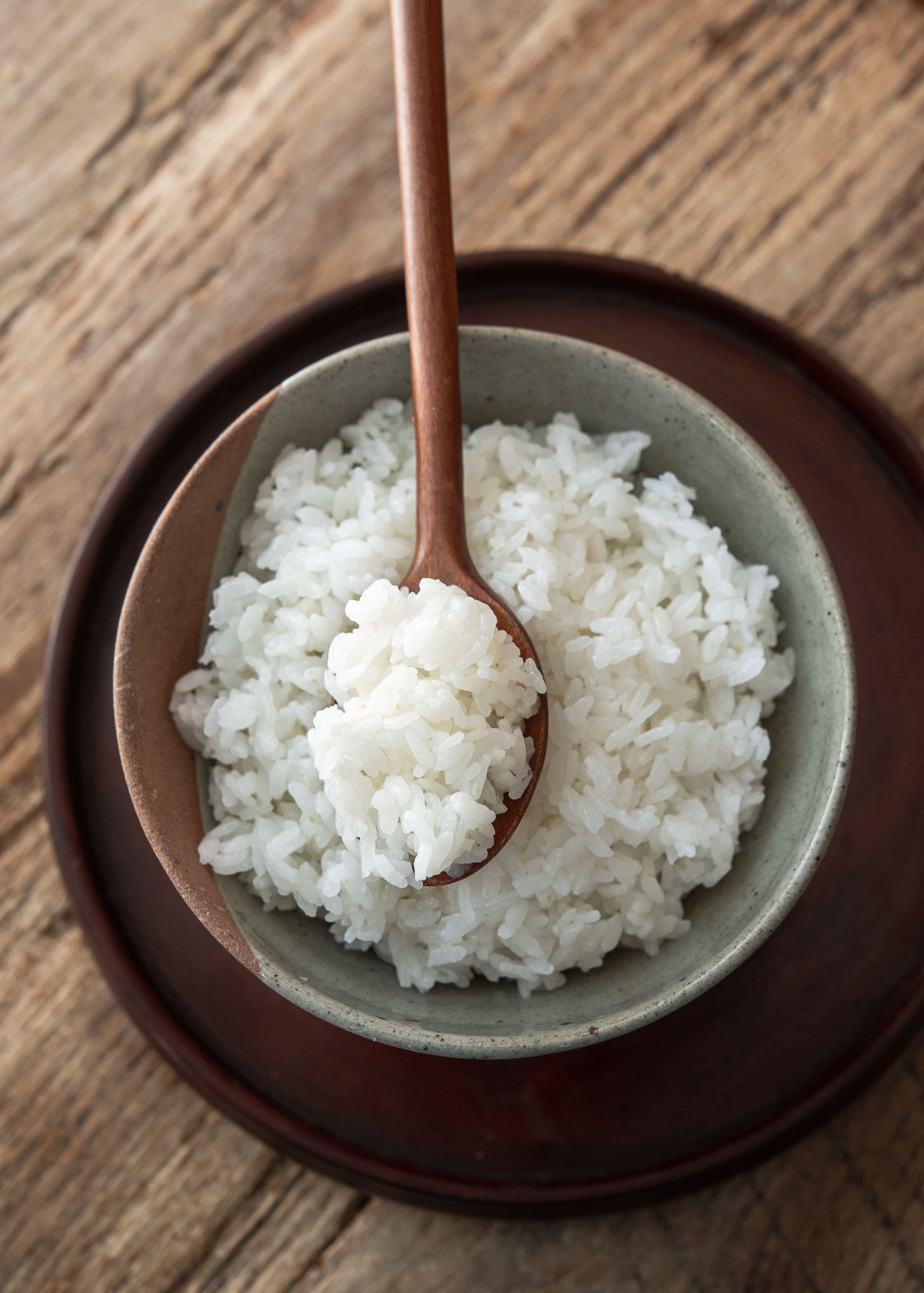 A spoonful of stove top Korean rice (short grain rice) in a bowl.