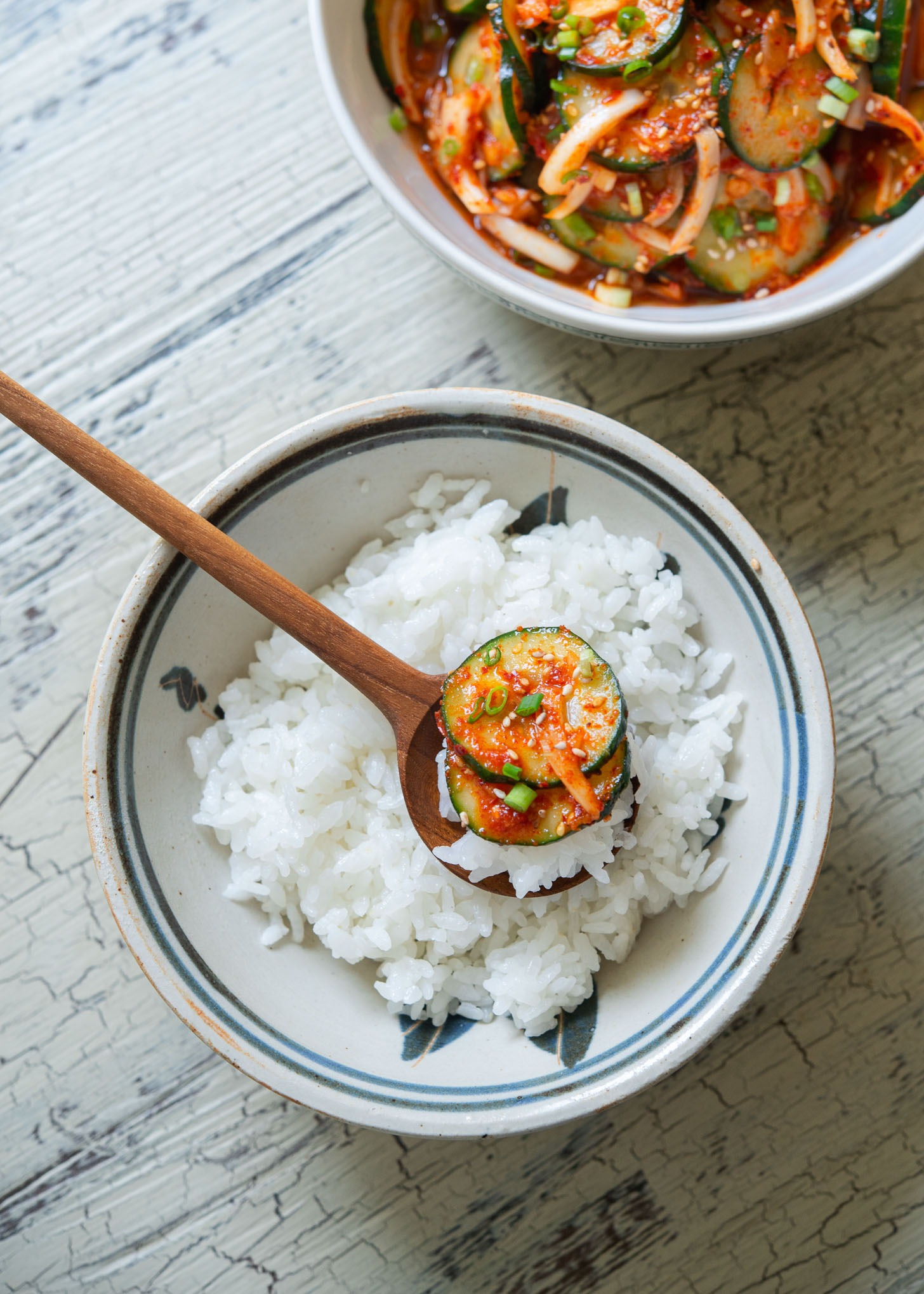 Spicy cucumber salad (Oi-muchim) served with rice as Korean cucumber side dish.