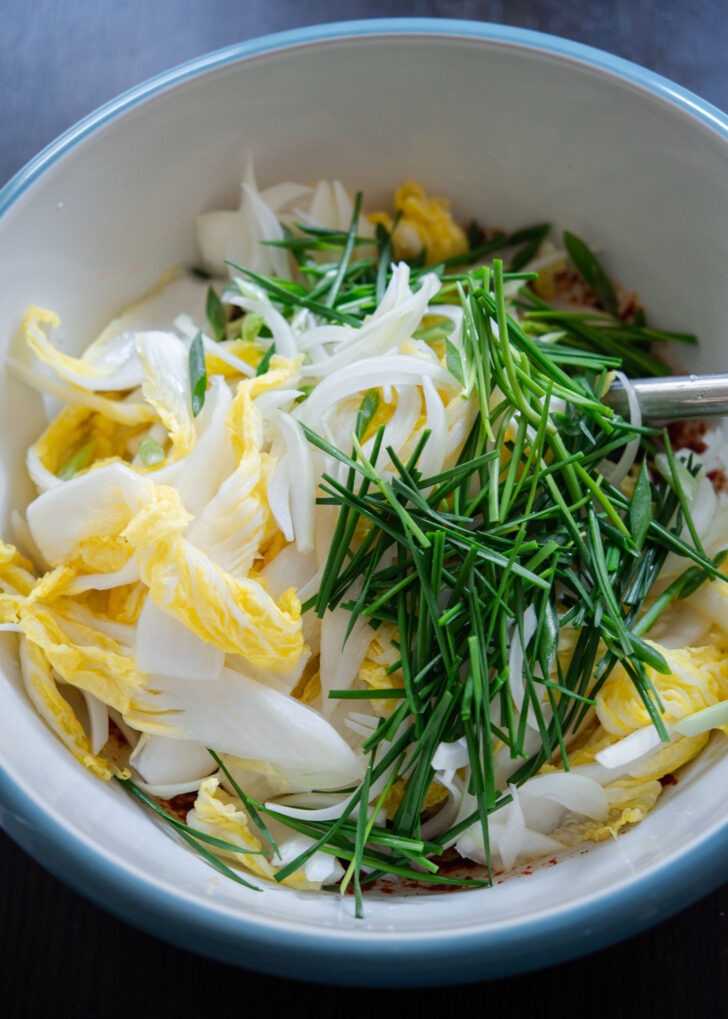 brined cabbage, onions, and chives added to the geotjeori seasoning paste.