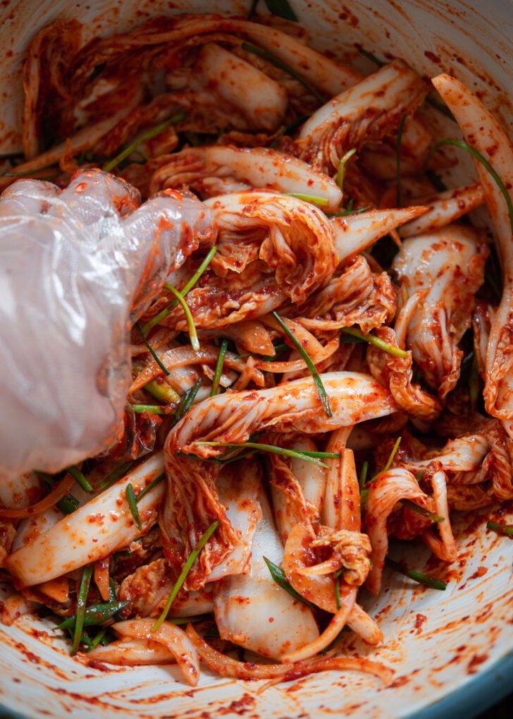 Geotjeori kimchi salad is hand tossed with seasoning paste.