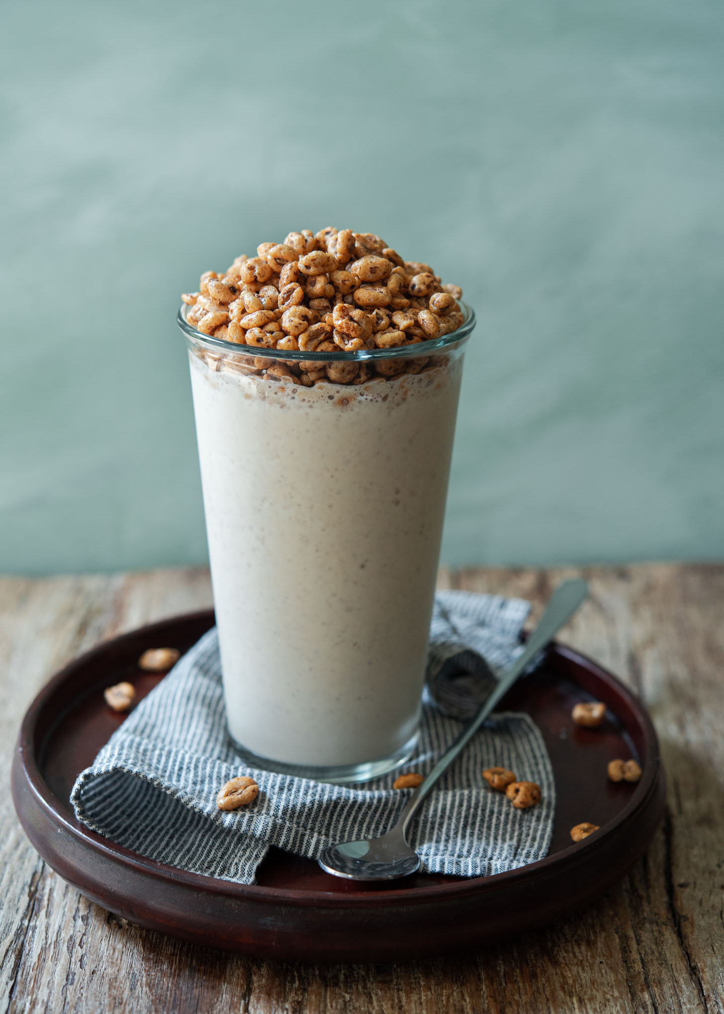 Korean cereal milkshake topped with jolly pong cereal in a glass.