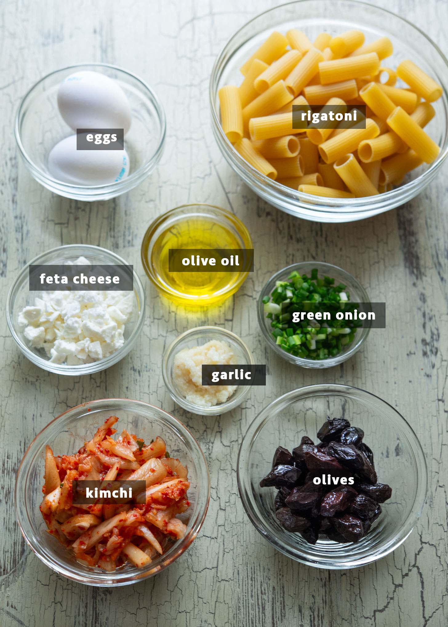 Ingredients for making kimchi olive pasta, Mediterranean-Korean fusion style.