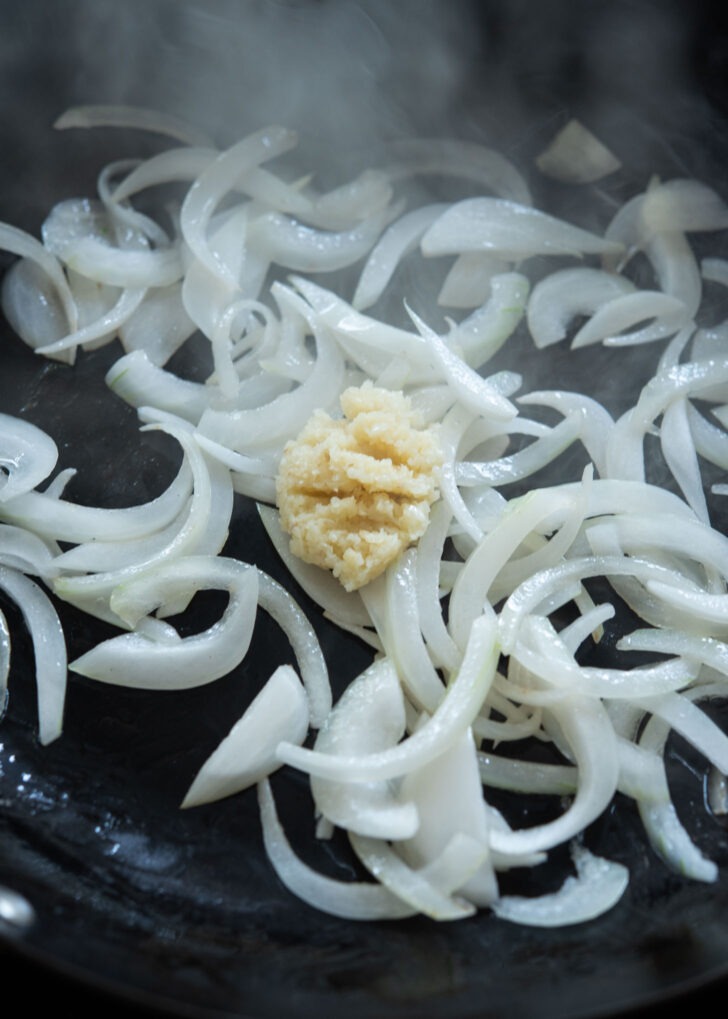 Onion and garlic stir-frying in a skillet