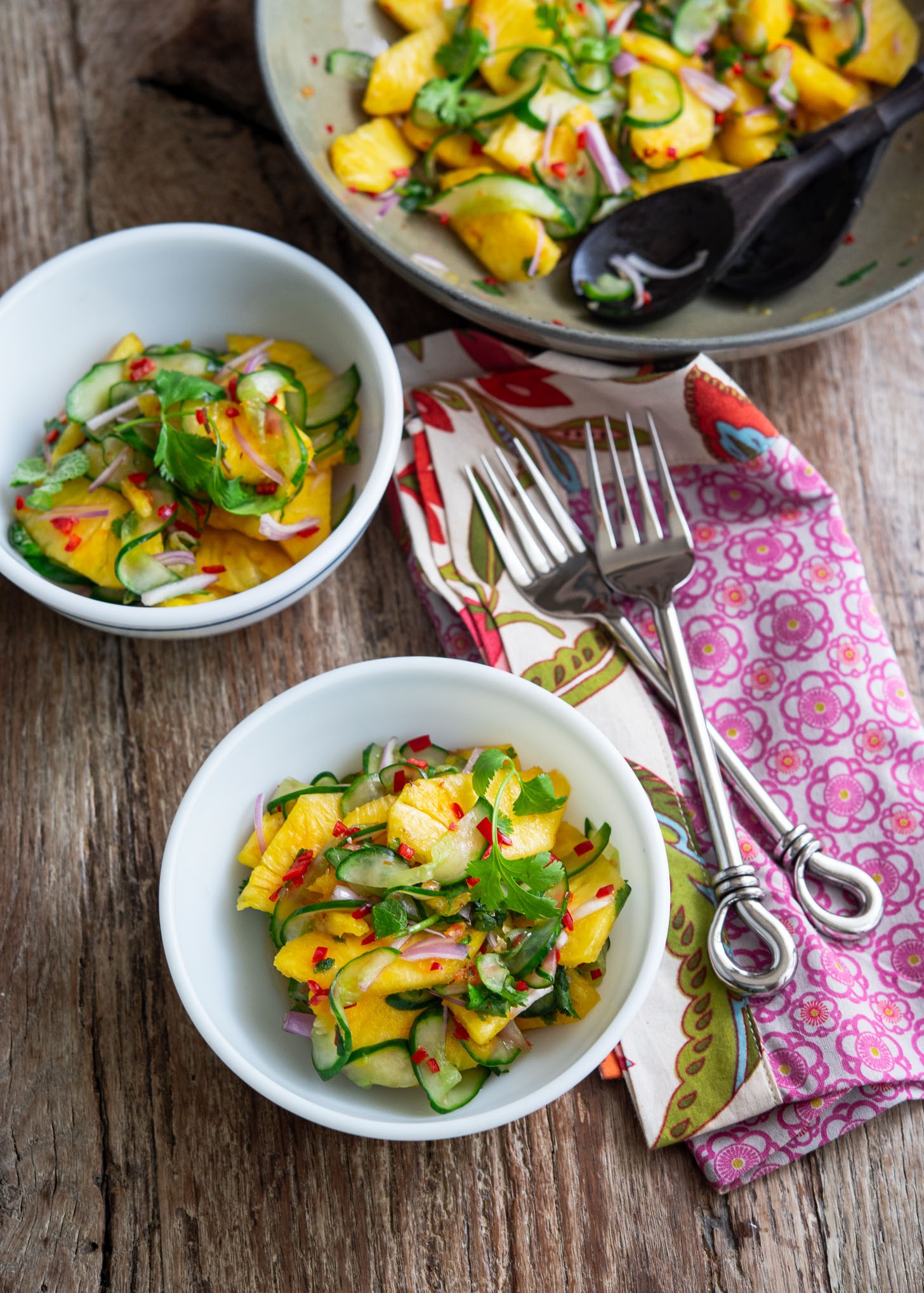 Pineapple cucumber salad in serving bowls.