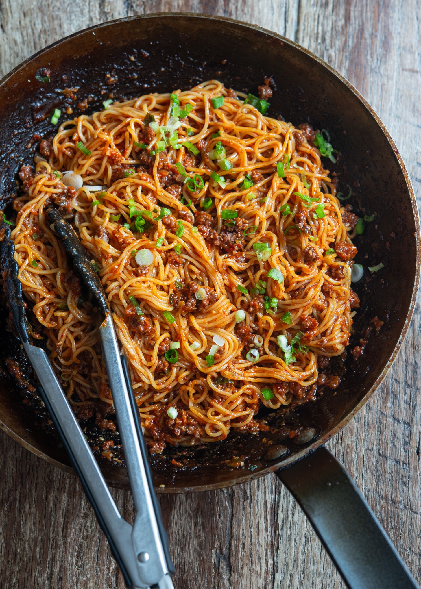 A skillet filled with beef gochujang noodles