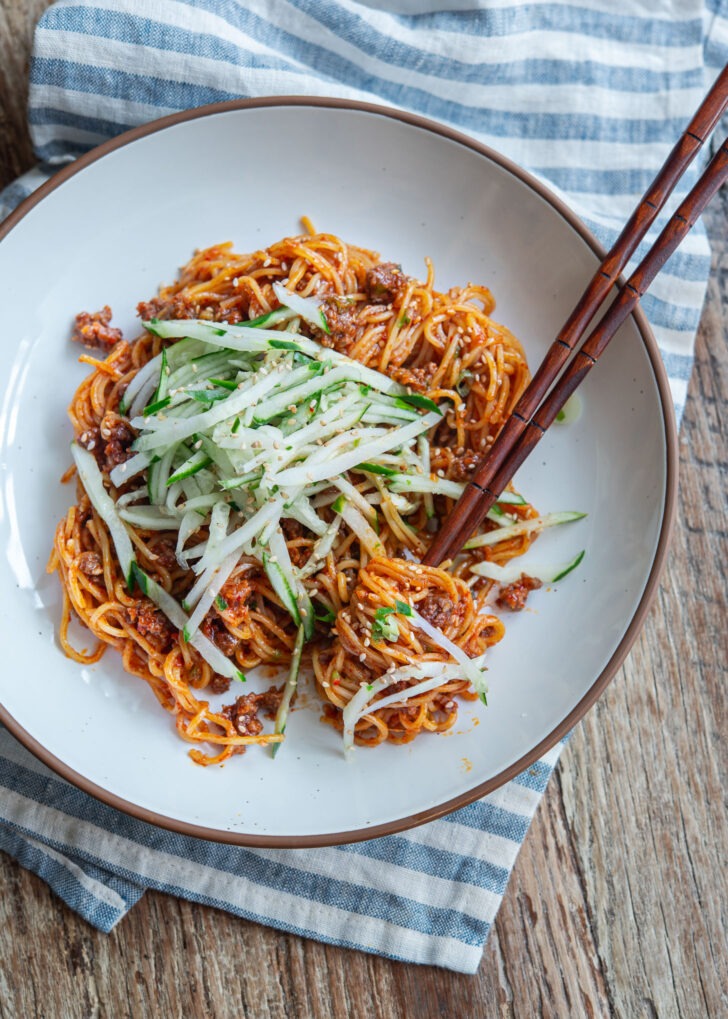 Korean gochujang noodles with beef and cucumber served in a bowl