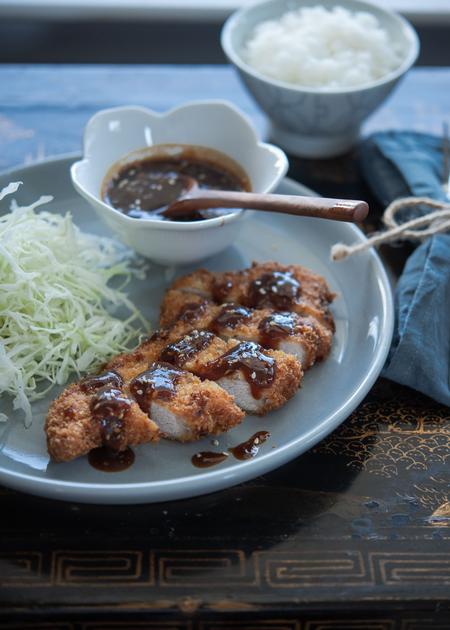 Japanse pork cutlet paired with tonkatsu sauce and shredded cabbage.
