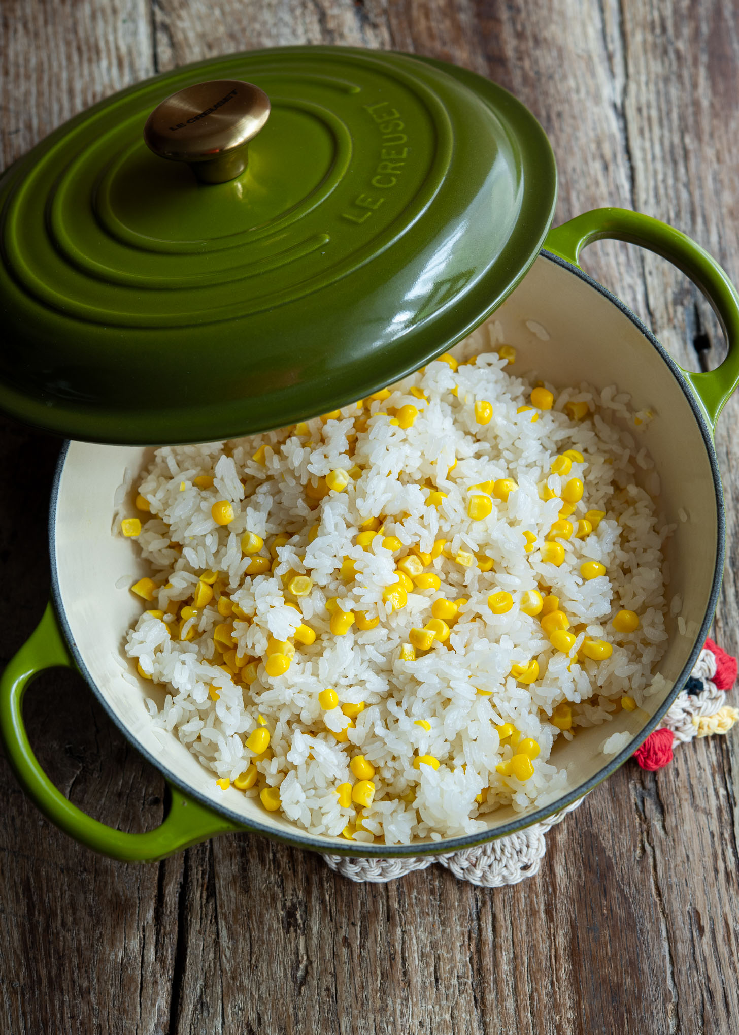 Fresh sweet corn and rice cooked together to make oksusu bap  in a pot 