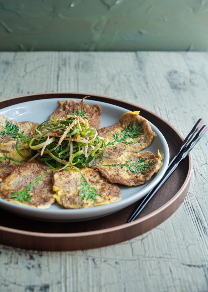 Yukjeon paired with Korean green onion salad.