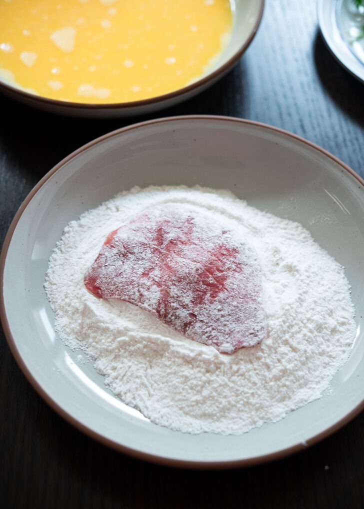 Coating thin beef slice with flour to make Korean beef pancake (yukjeon)